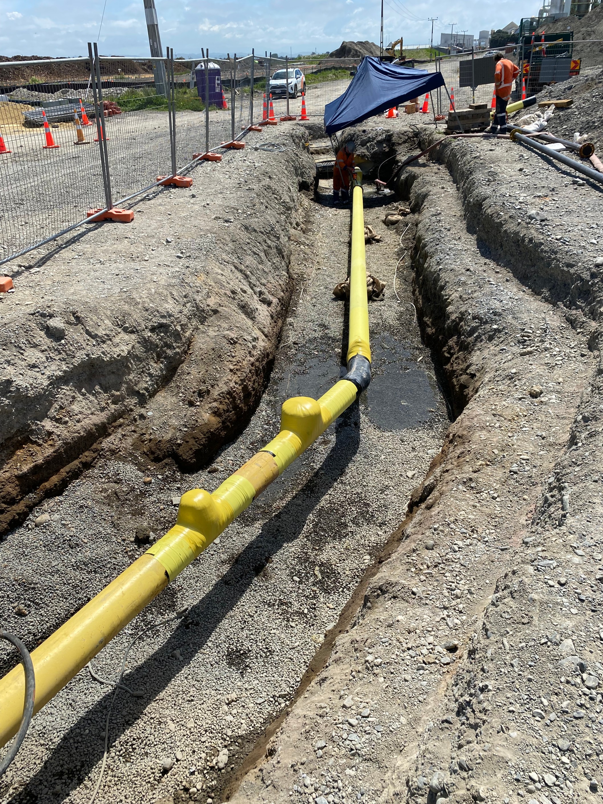 A yellow gas pipe in the ground.