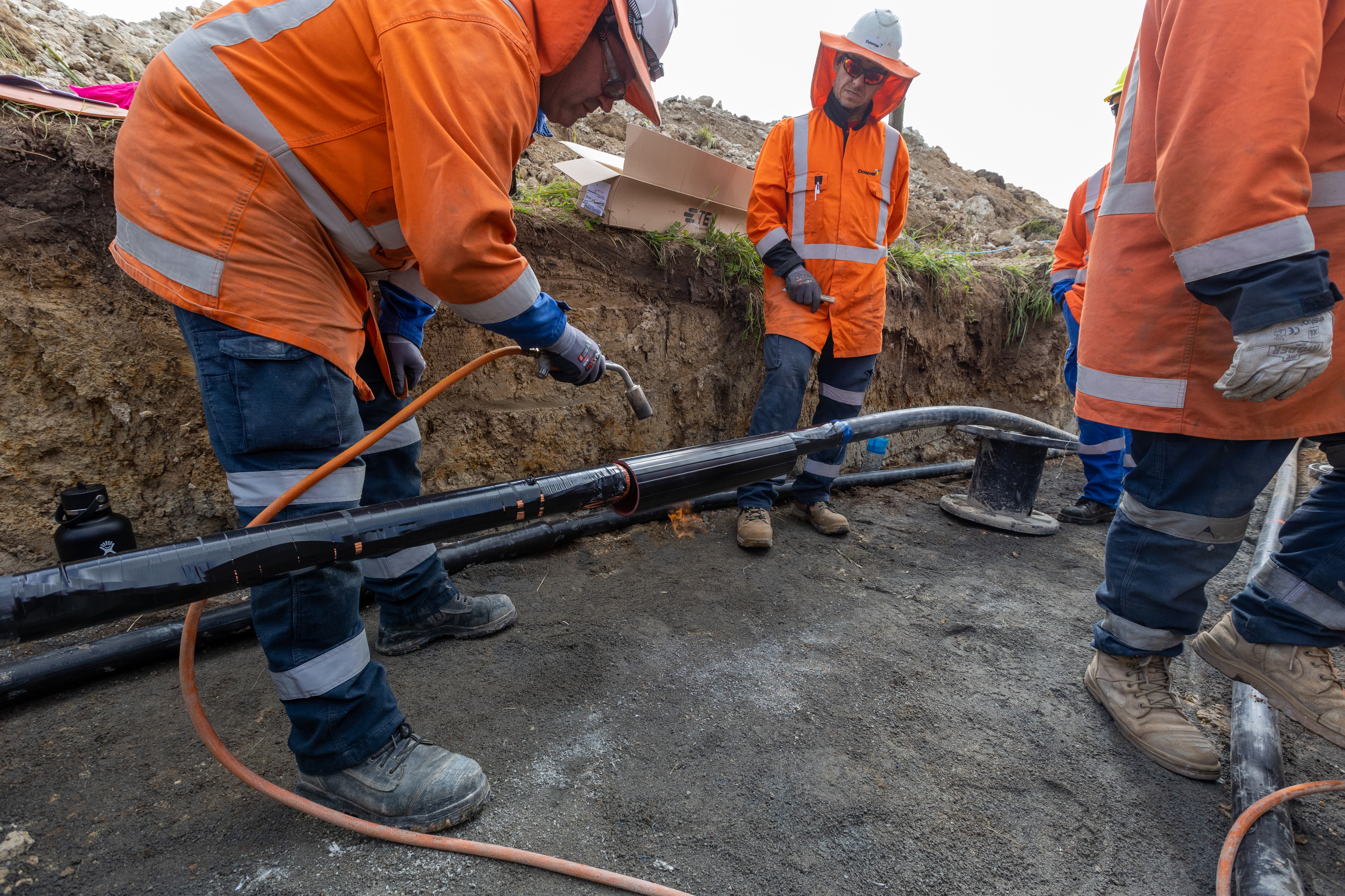 Field crews doing cable jointing in a trench