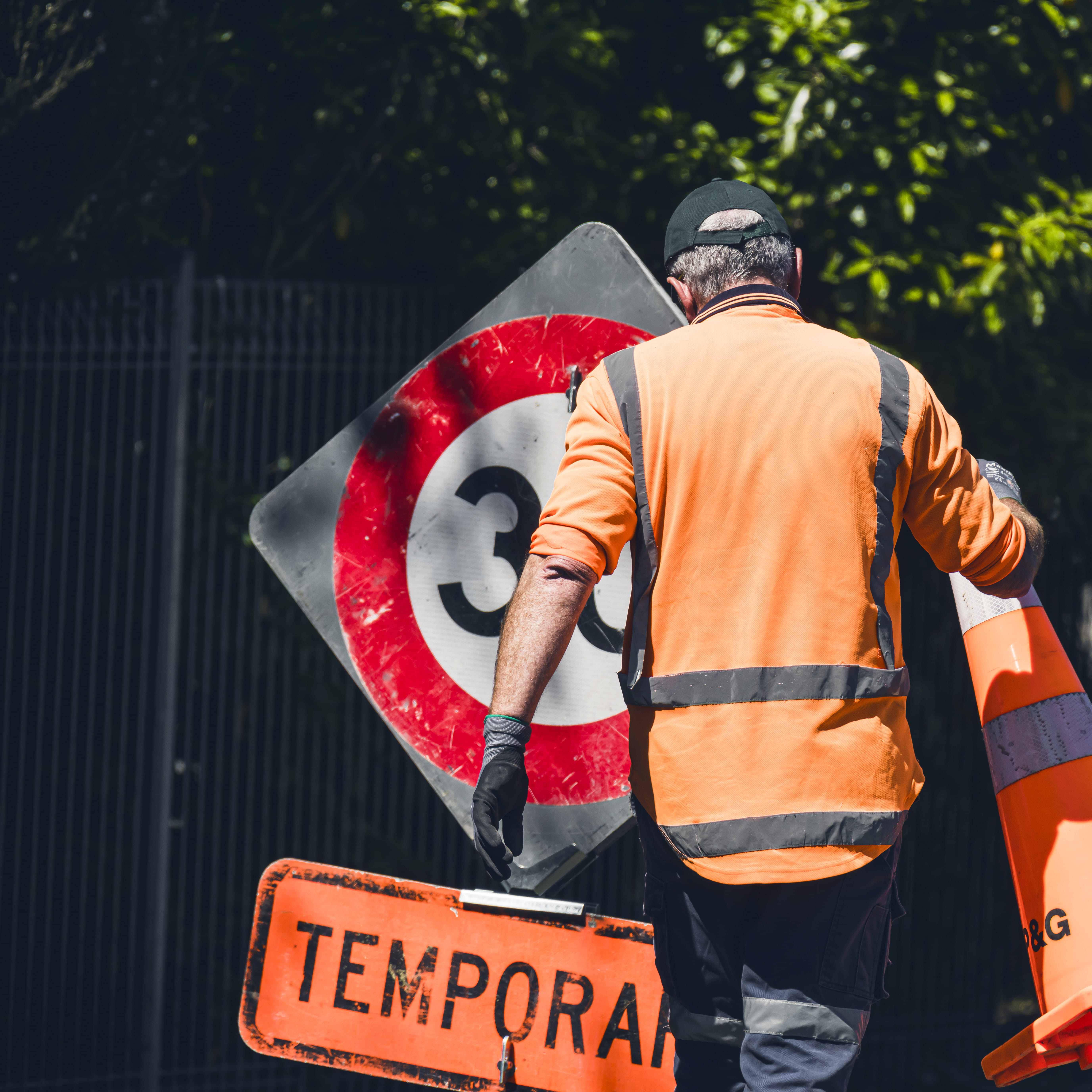 Worker moving road signs. 