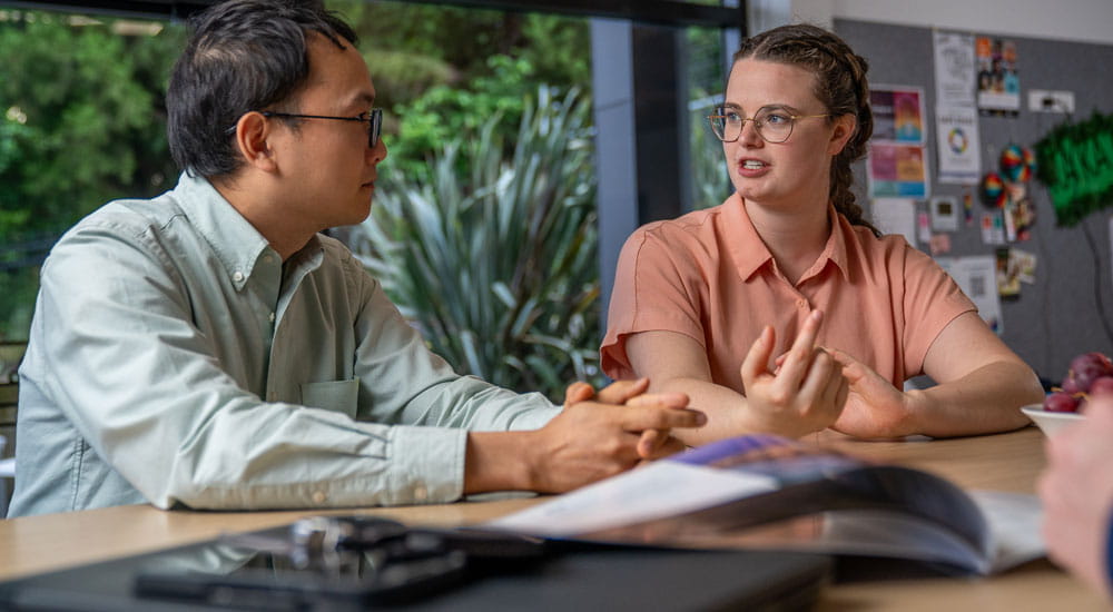 man and woman in office talking