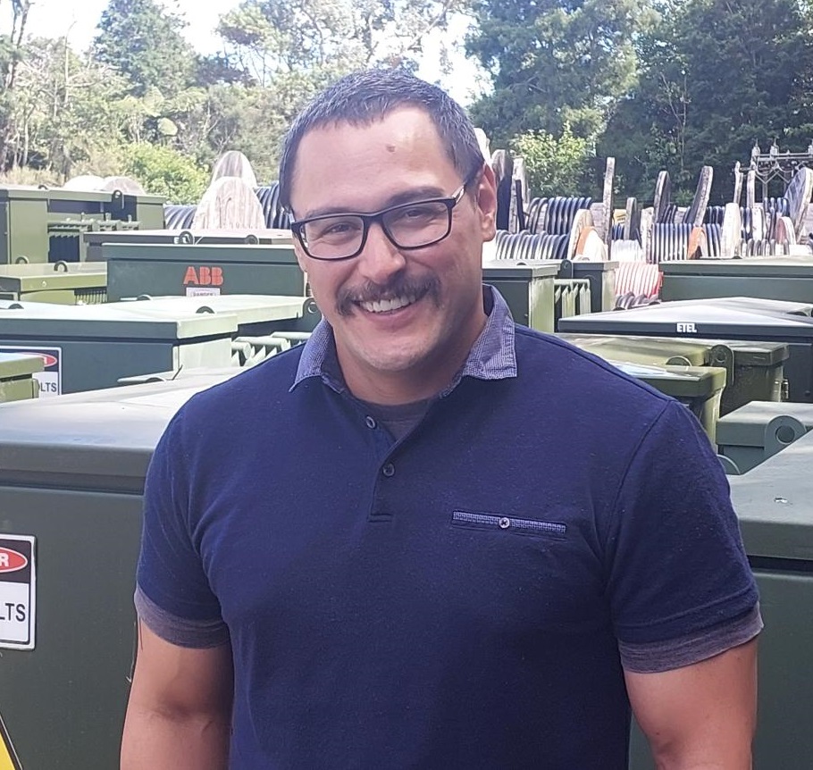 Maori man with glasses smiling