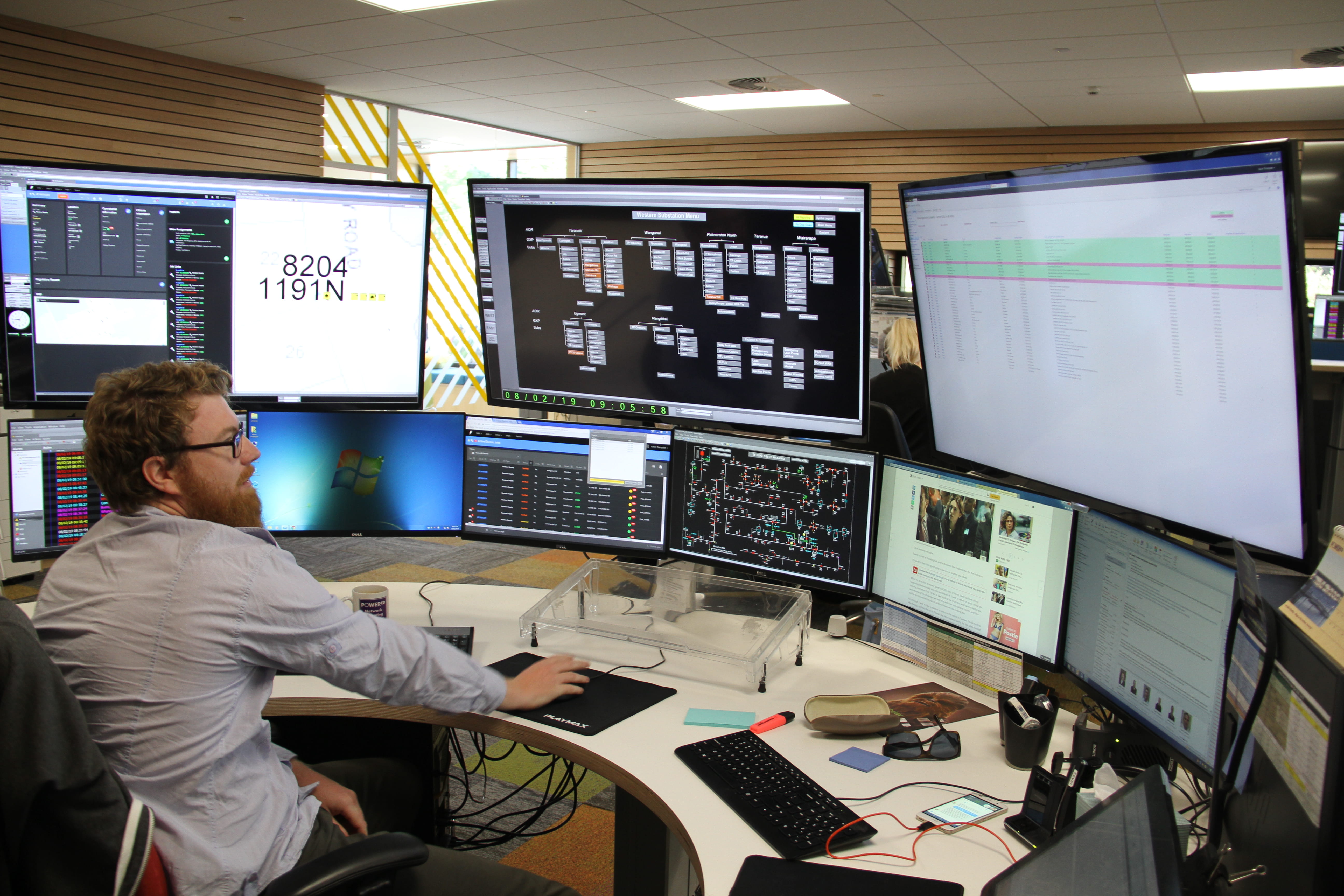 Network Operations Centre team member working at computer screens.
