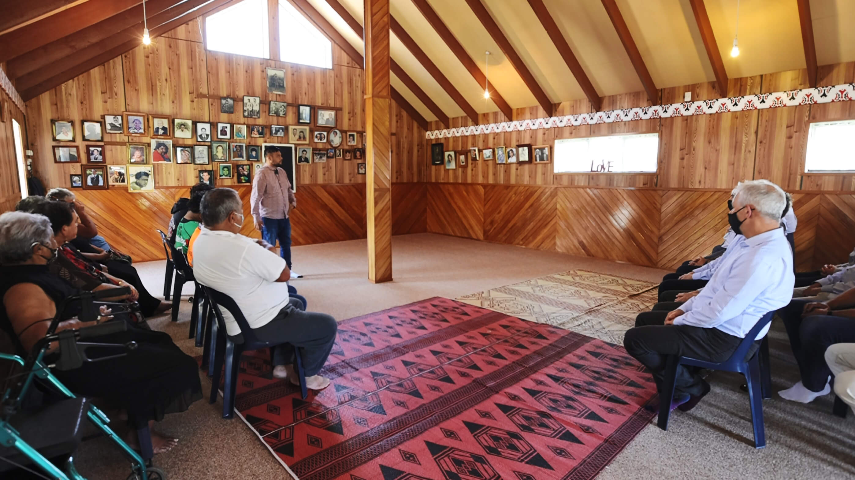 Group listening to a speaker inside a marae