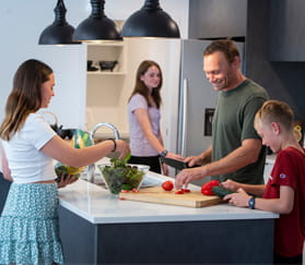 family cooking in kitchen