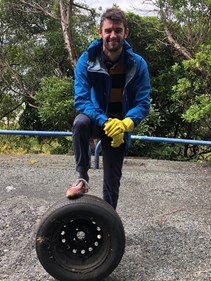 Powerco team member with a discarded tyre