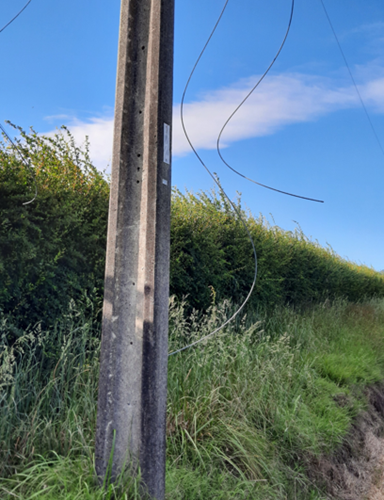 Loose wires hanging from a pole