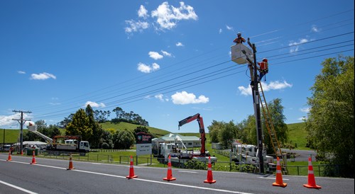 Field crew working up pole on overhead lines