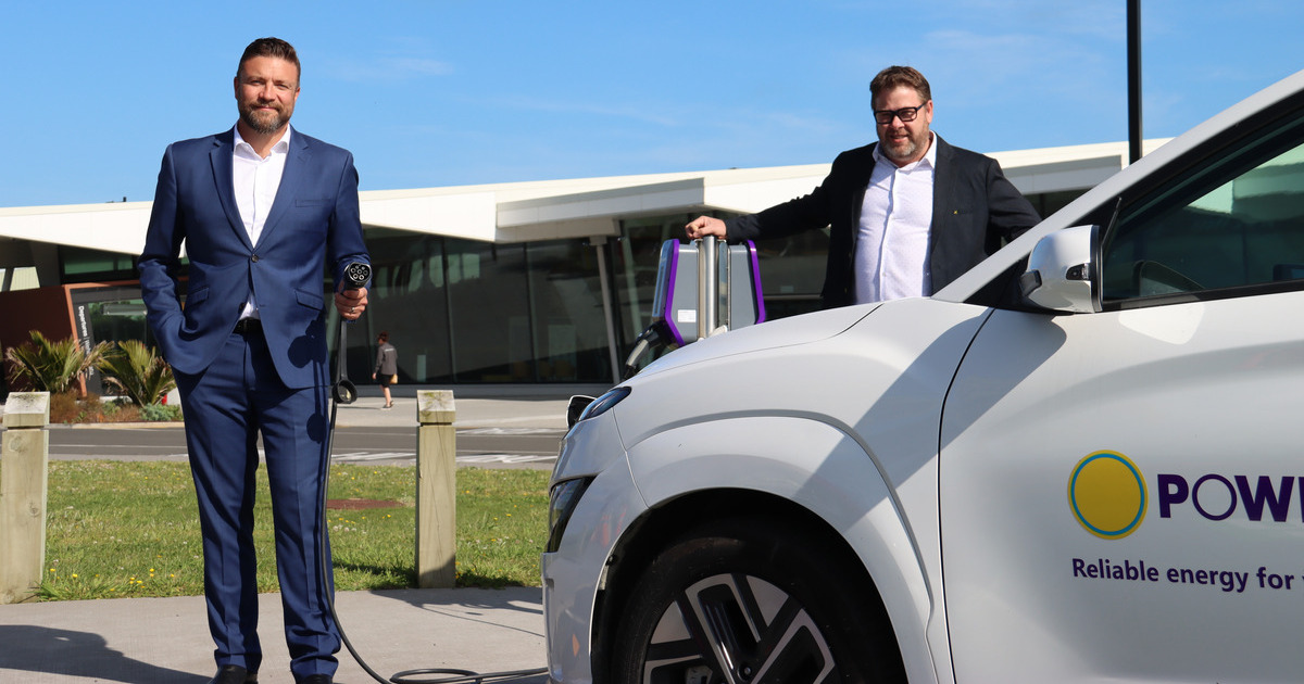 Powerco's Eric Pellicer and New Plymouth Airport's David Scott charging an EV.