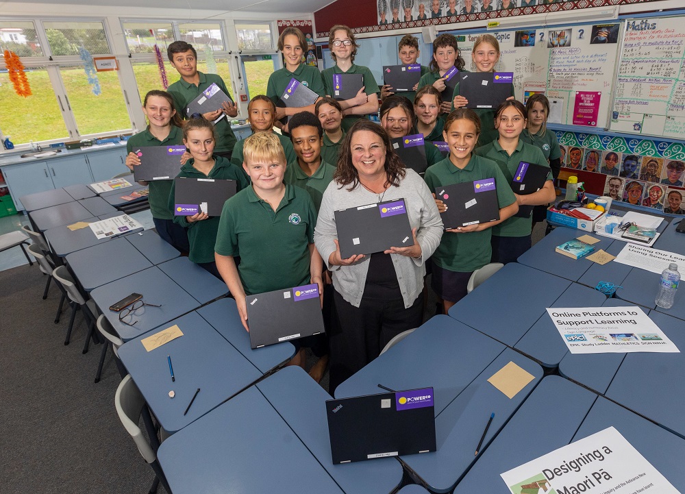 Te Aroha Primary School Deputy Principal and classroom teacher, Holly Brittenden, with her Year 8 students who are benefiting from the donation of laptops from Powerco.