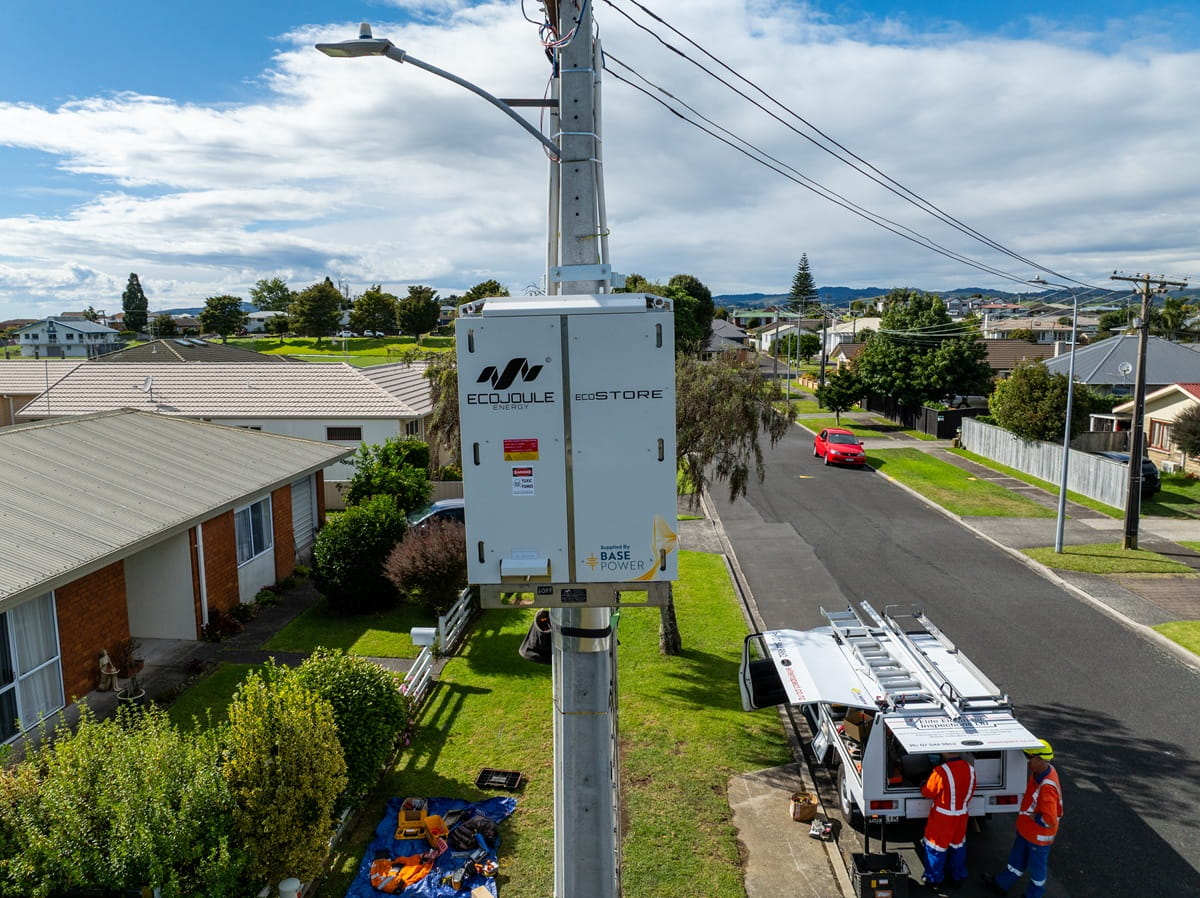 Aerial footage of an electrical box connected to a concrete pole pole.