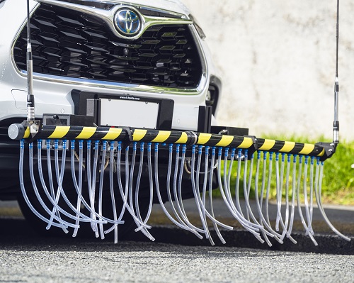 More than 40 plastic tubes protruding from the front bumper of a vehicle