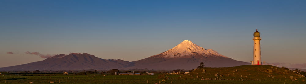 Cape Egmont and Taranaki mounga at sunset.