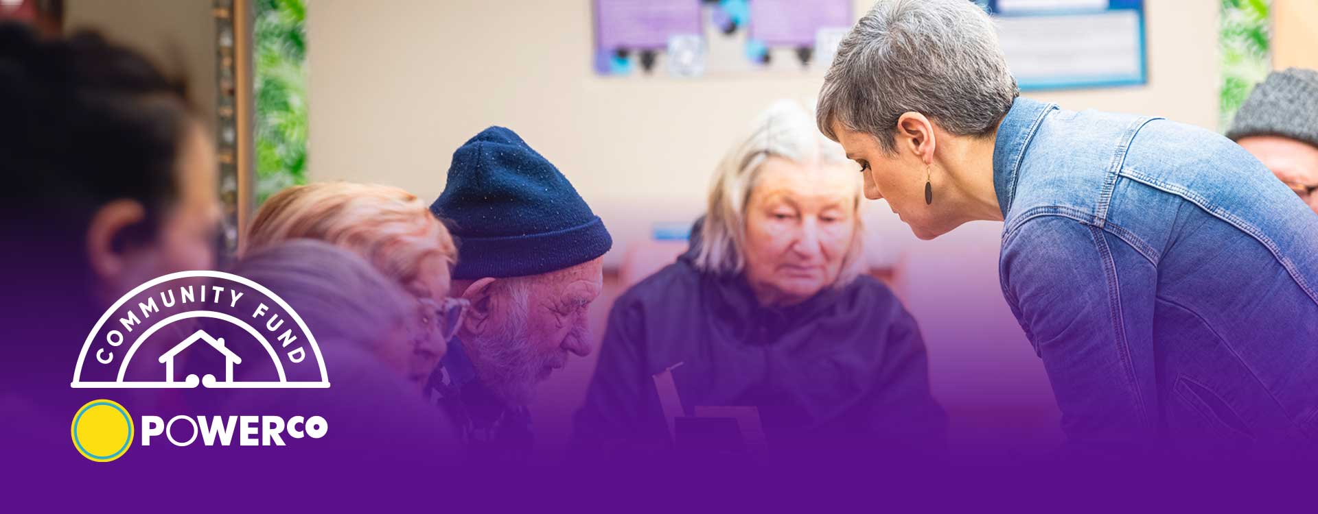woman talking to a group of older people at community event
