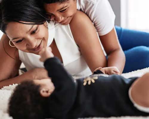 Mother smiling at young child