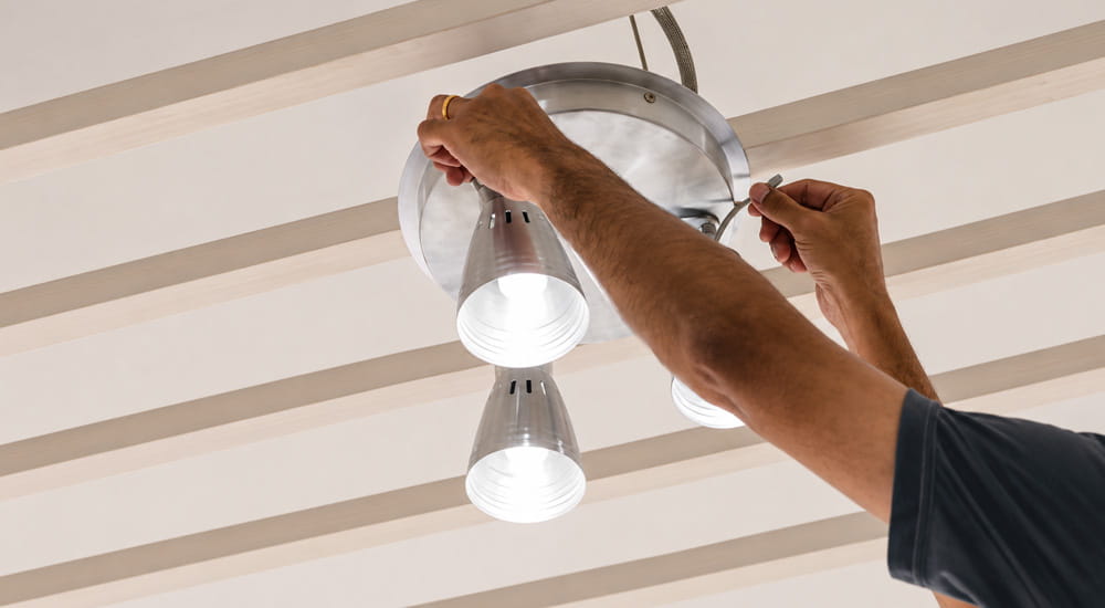 person changing light bulb