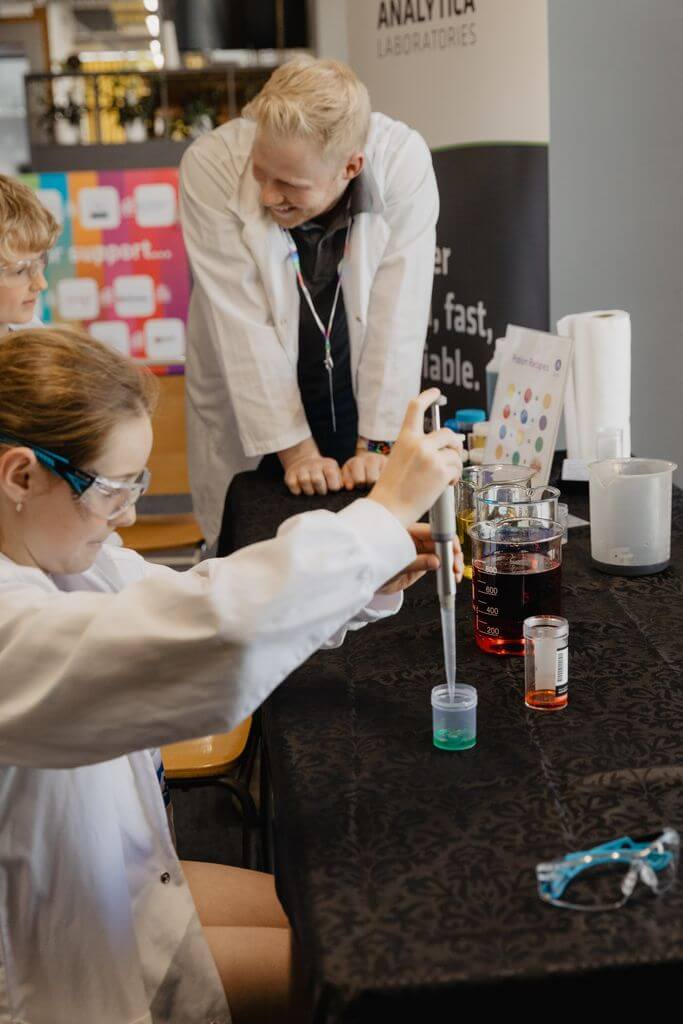 teacher guiding STEM students