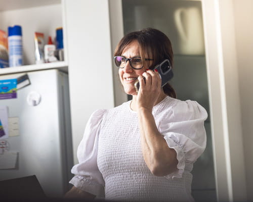 woman on phone in kitchen