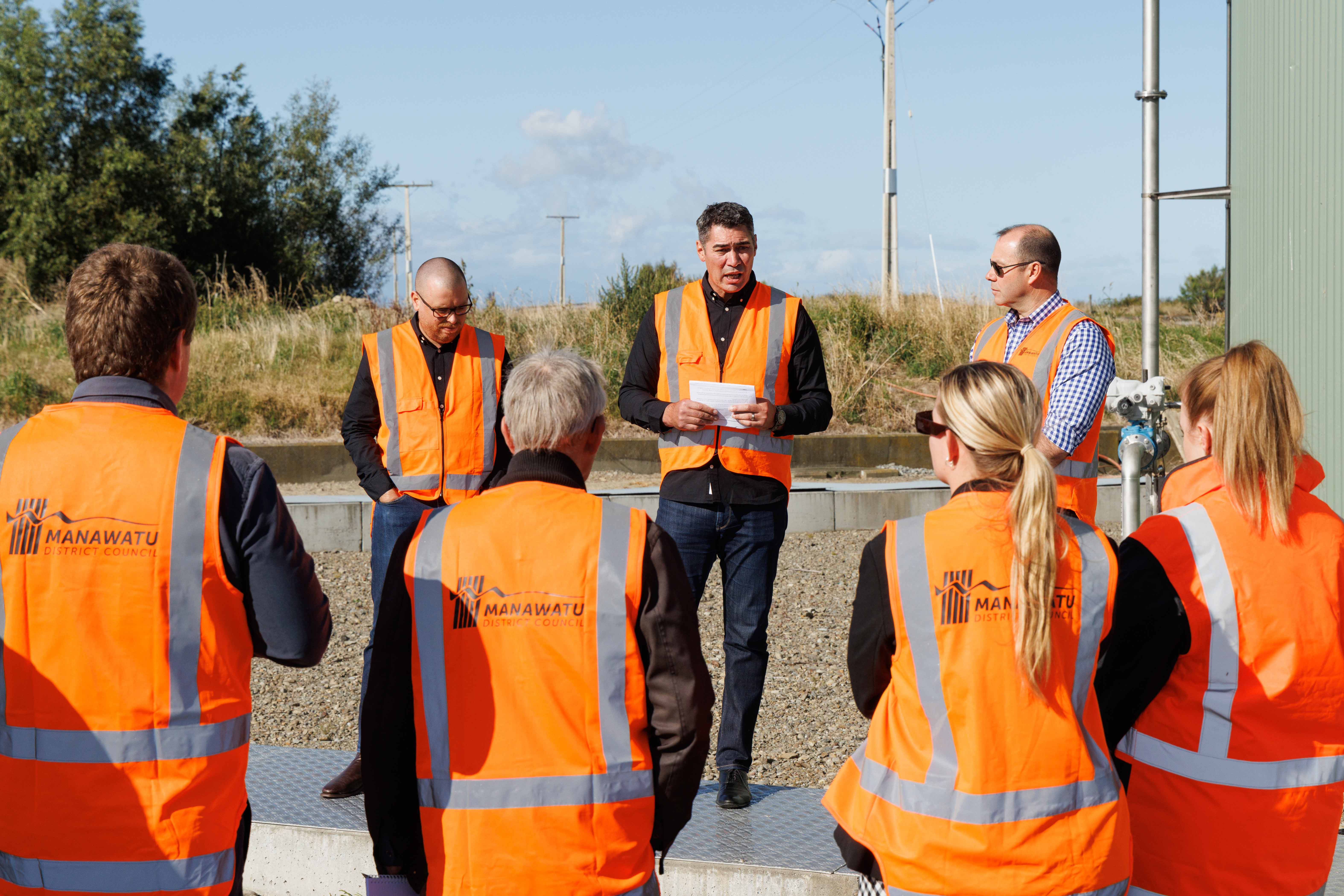 Powerco staff talking at biogas location in Feilding