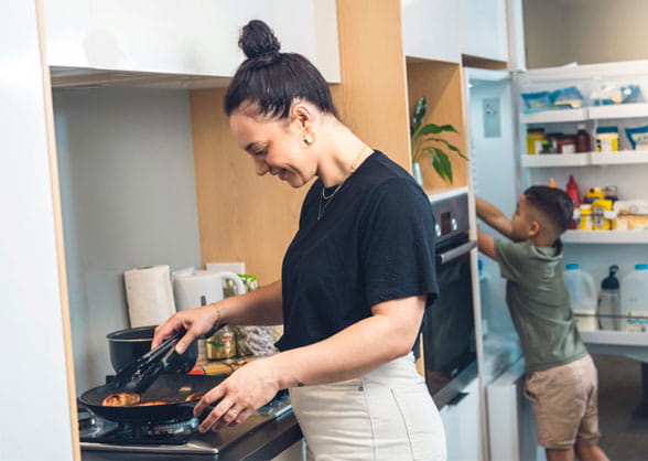 woman cooking on gas appliance
