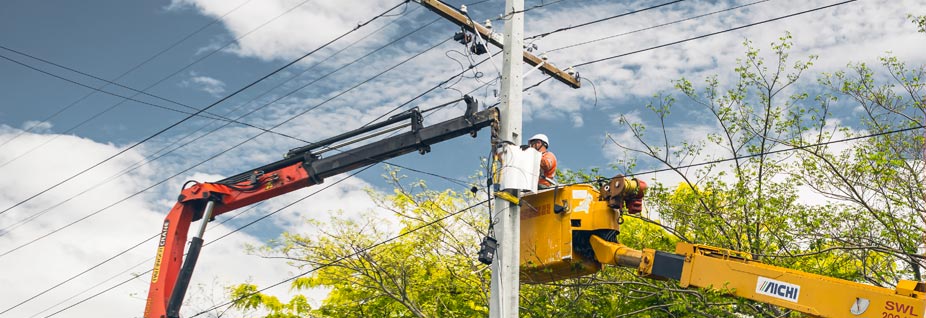 Field crew upgrading overhead lines from a cherry picker