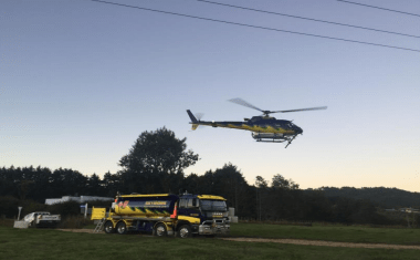 A helicopter taking off at dawn.