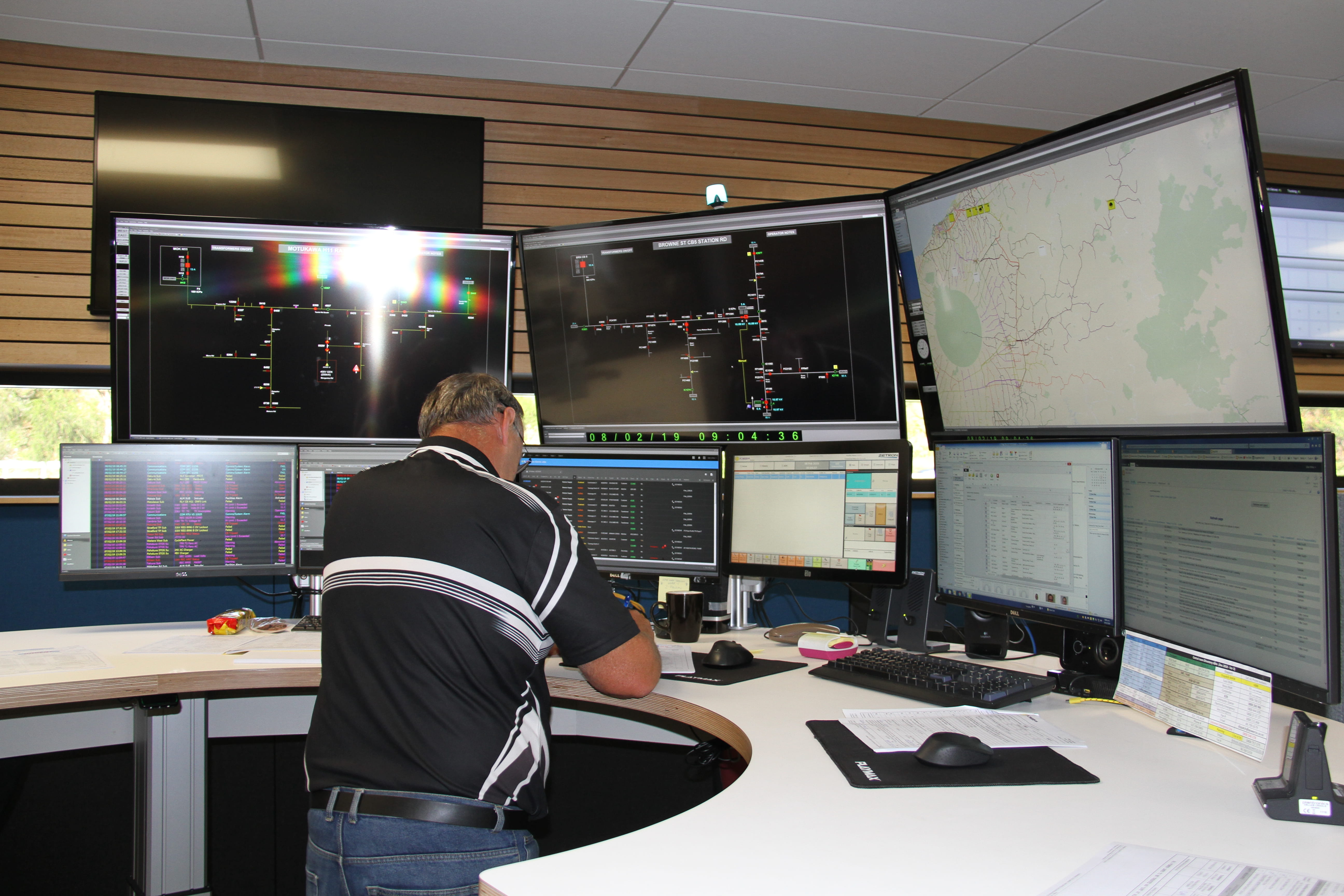 Network Operations Centre team member working at computer screens.