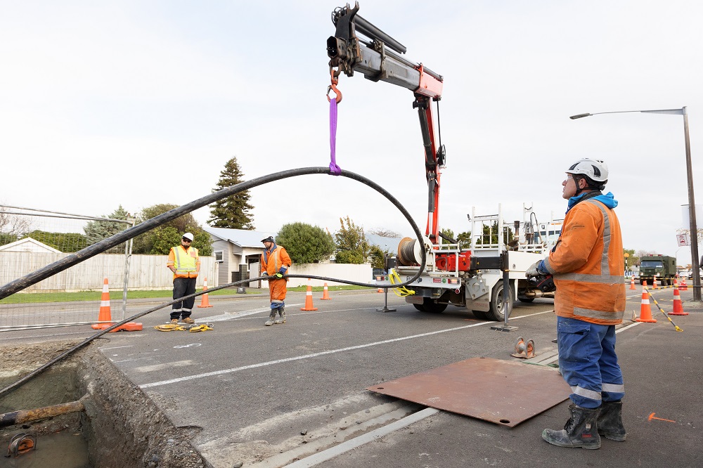 Electricity cable being lowered into the road