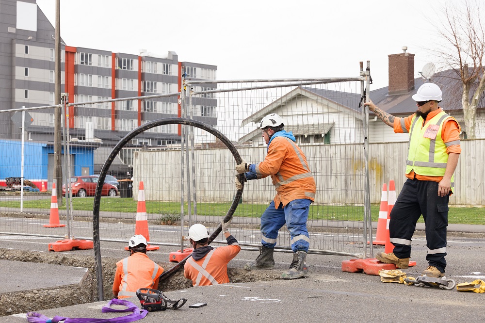 Cable being hauled through a hole in the road