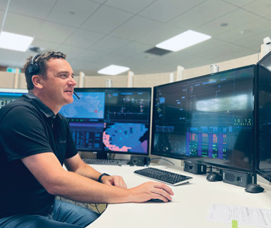 man looking at multiple computer screens