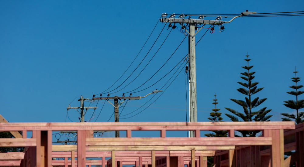 power poles with building construction in foreground